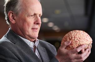 Steve Furber holding a brain